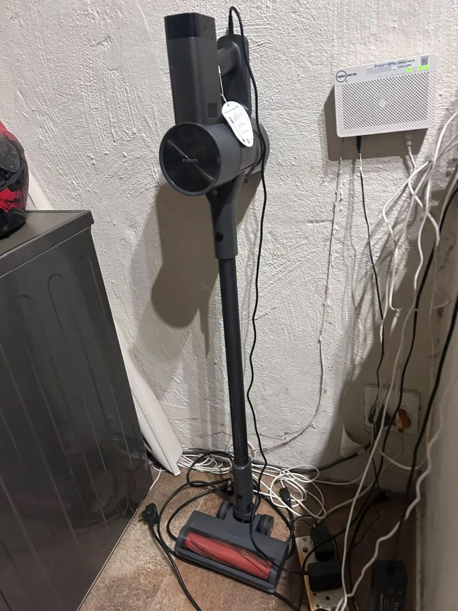 The household’s Xiaomi cordless vacuum on its wall mount.